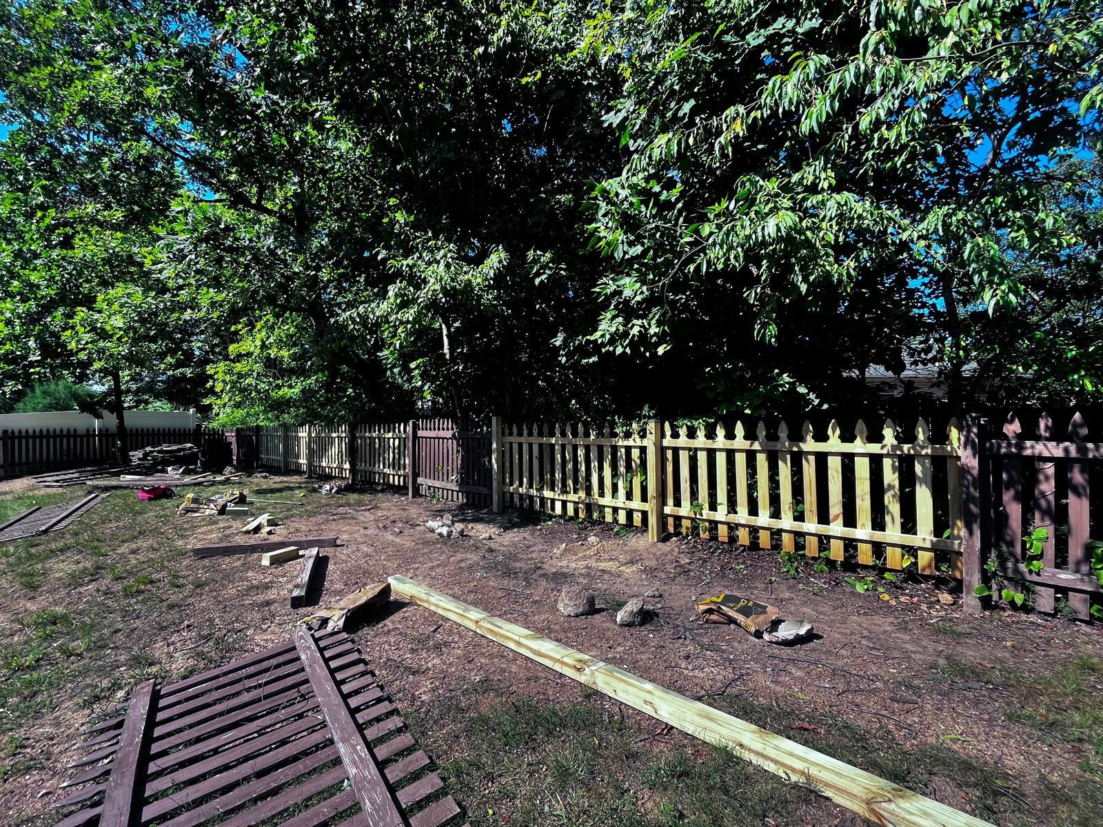 Backyard picket fence replacement in progress