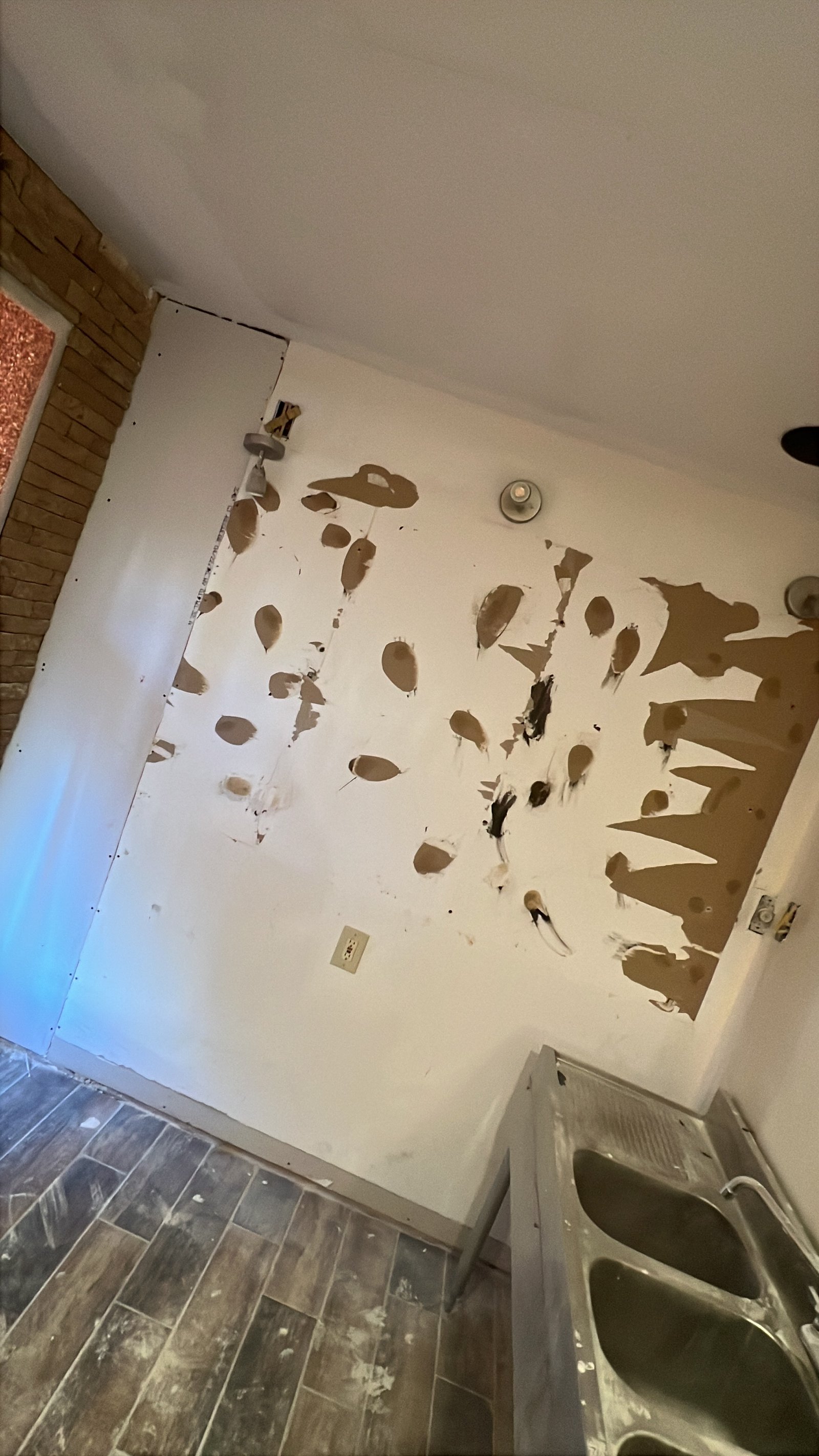 Damaged drywall wall prepared for repair
