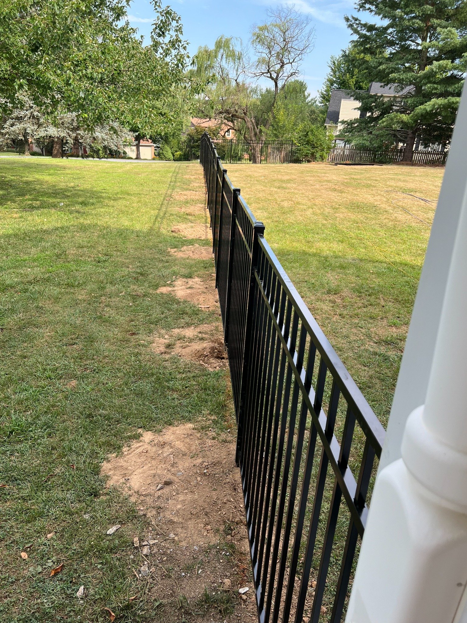 Finished black metal fence installation
